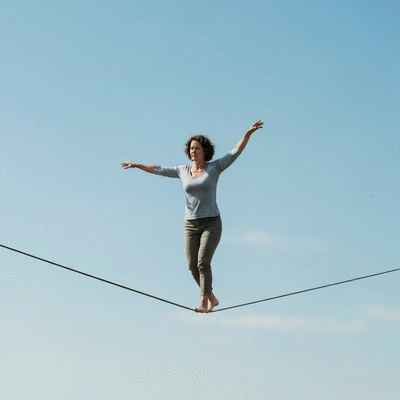 Person balancing on a tightrope, symbolizing the balance in integrative health
